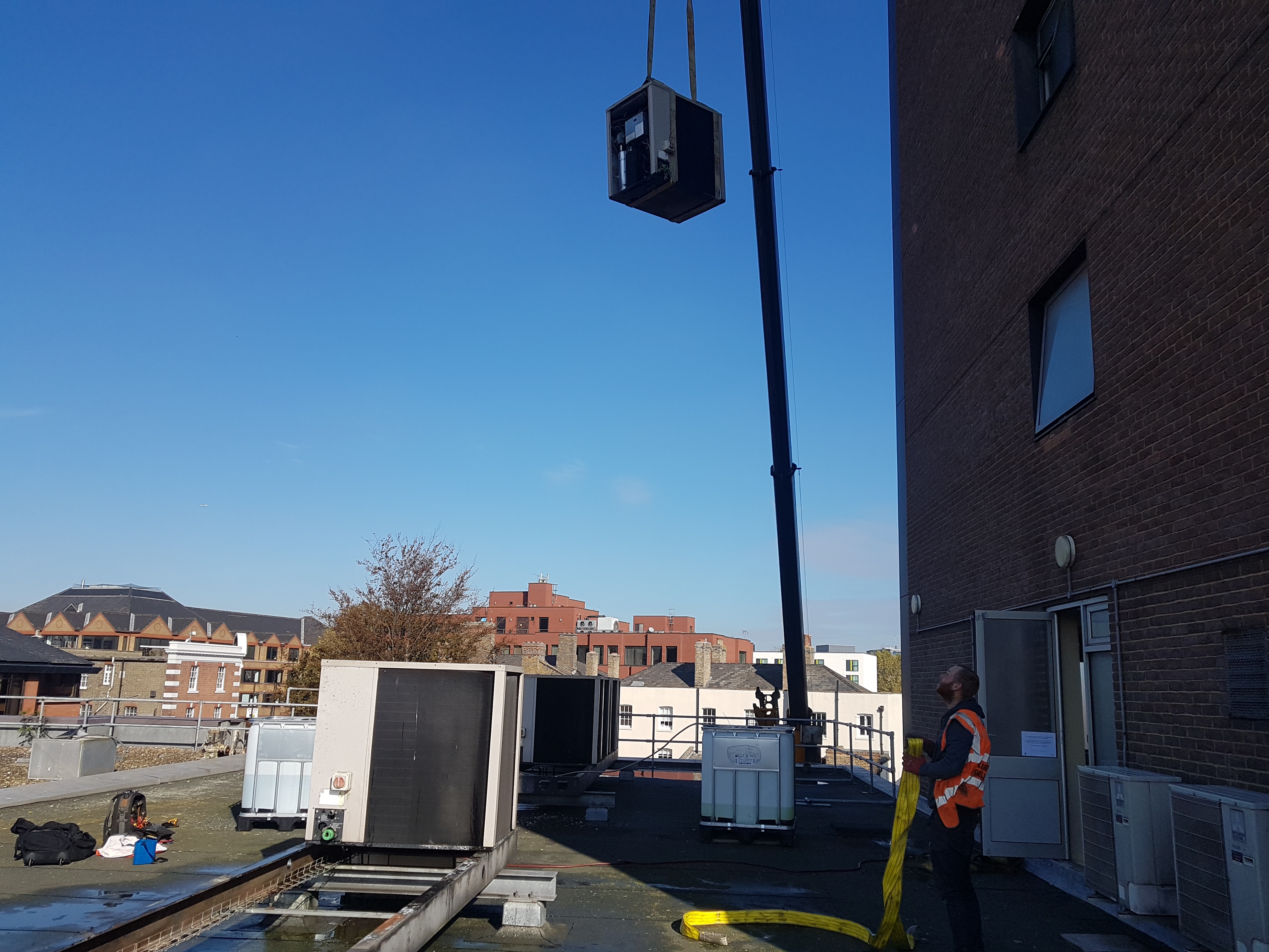 One of eight absorption chillers being lifted with a crane