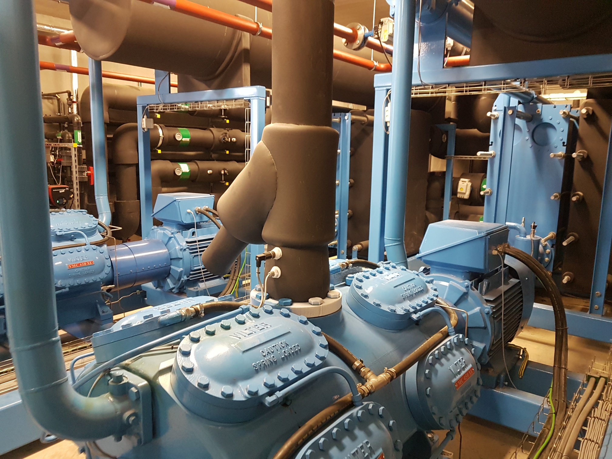 Machine room with blue and black glycol chillers during service maintenance and repair