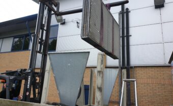 An R407c chiller condenser retrofit lifting operation outside in the compound