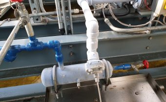 Frost covered blue oil return vessel during the removal of industrial refrigeration sludge