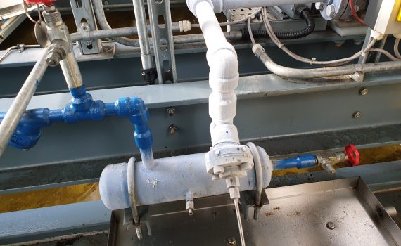 Frost covered blue oil return vessel during the removal of industrial refrigeration sludge
