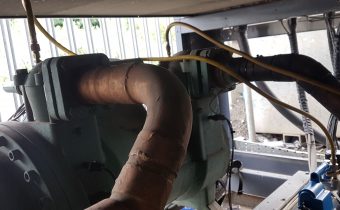 Green Bitzer compressor being vacuumed during HFC chiller service
