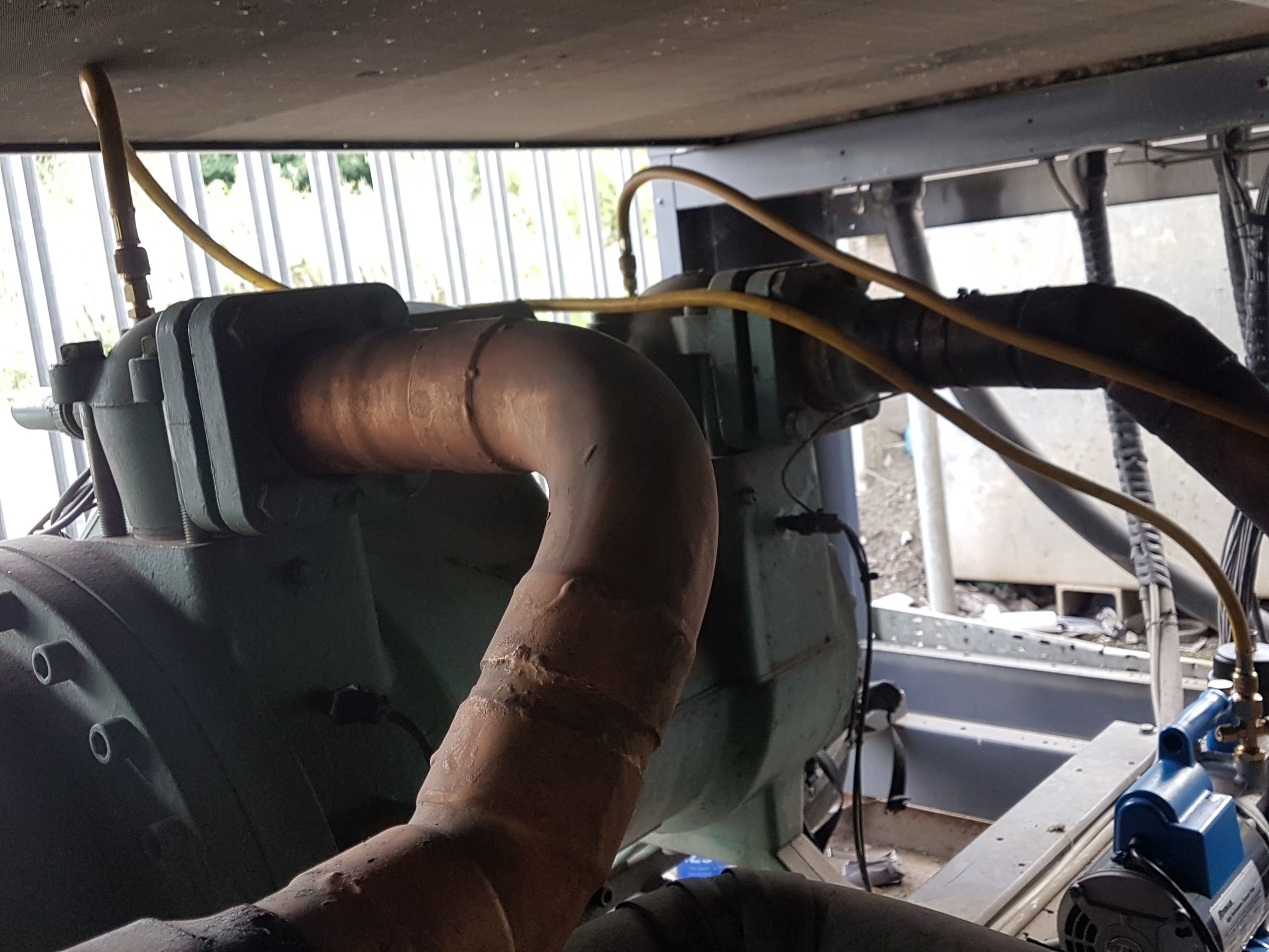Green Bitzer compressor being vacuumed during HFC chiller service