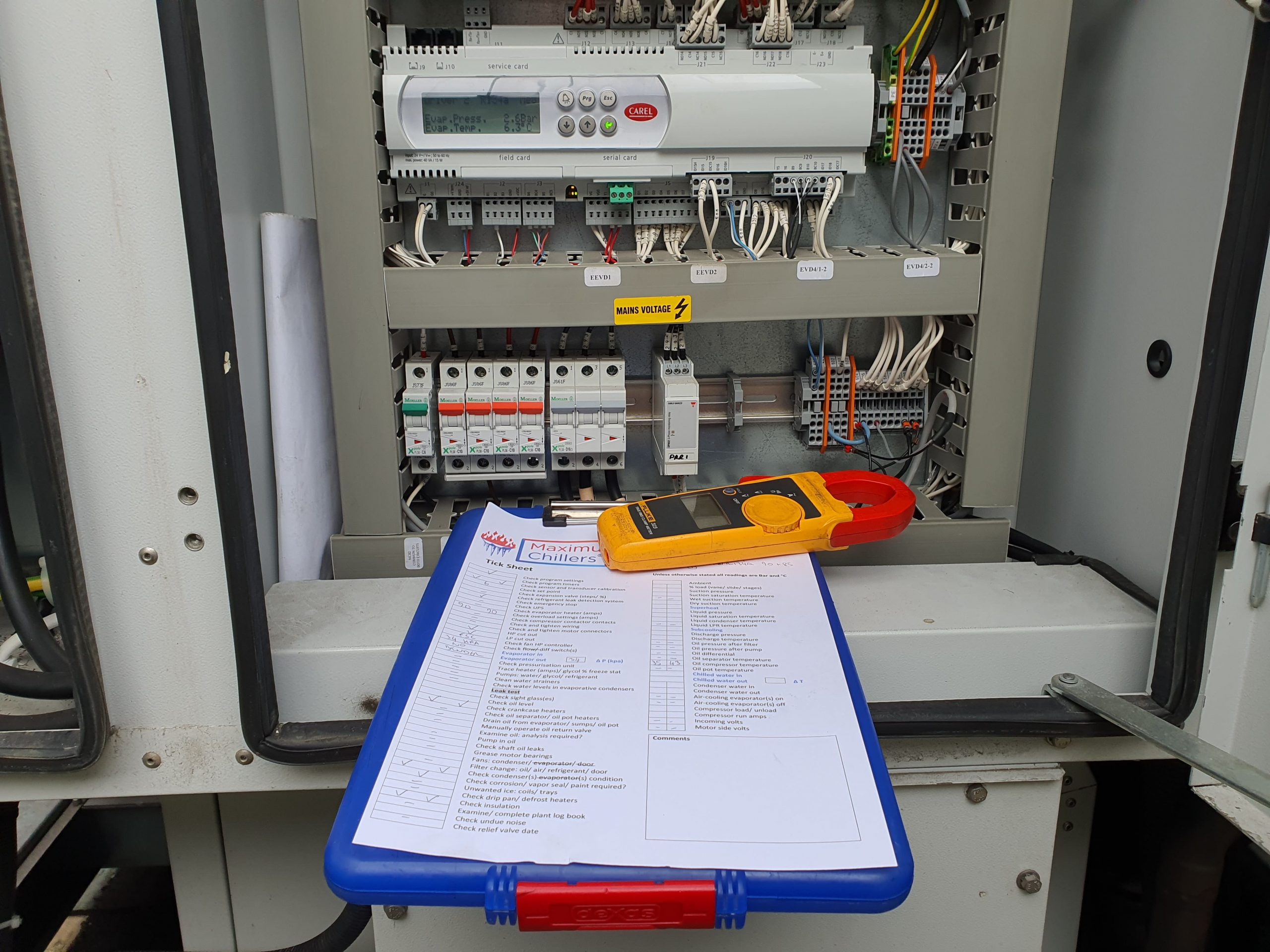 Carel controller and tick sheet during chilling plant maintenance visit