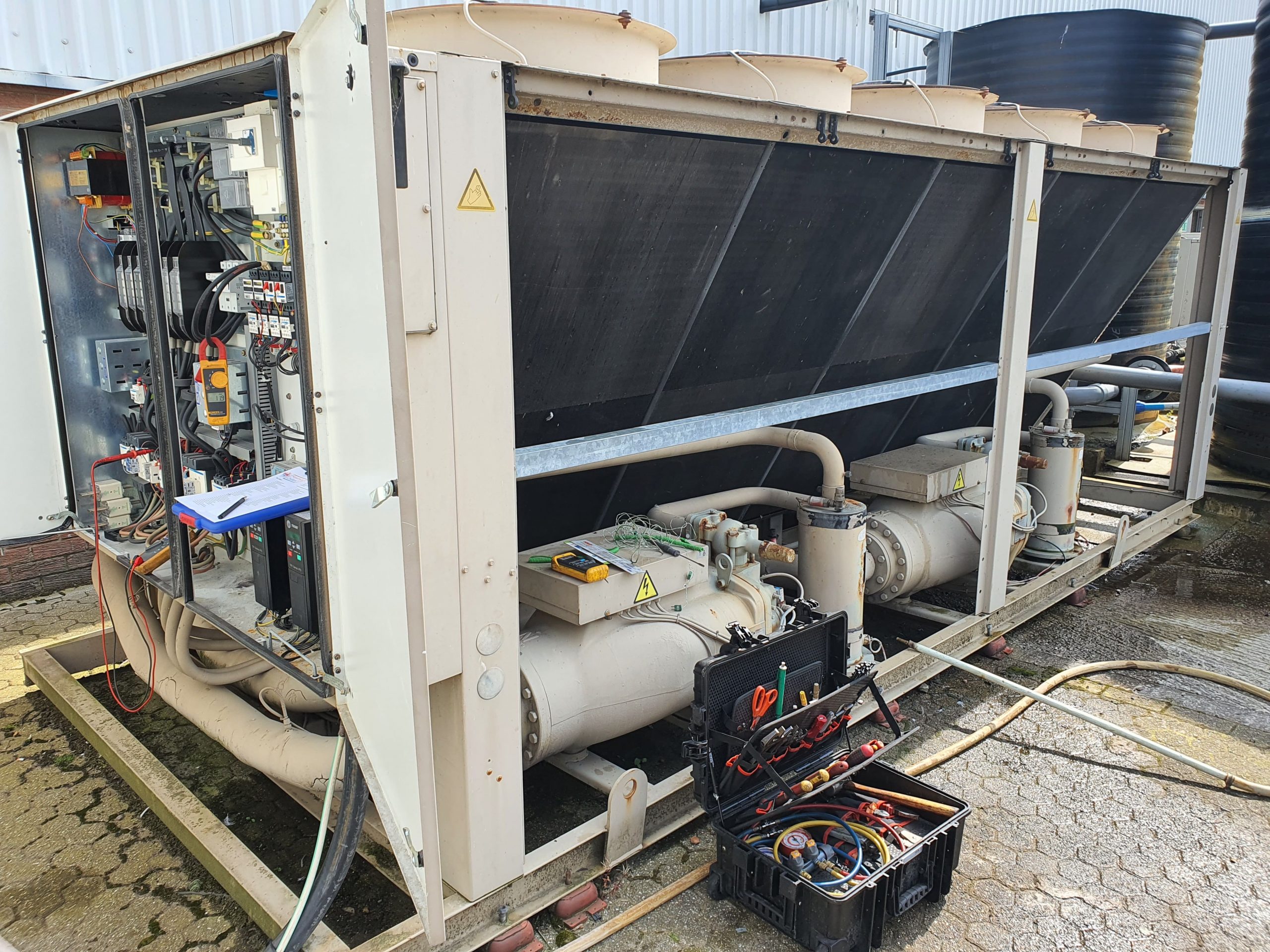 Large air cooled brown chiller with test equipment during planned preventative chiller maintenance