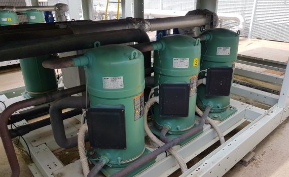 6 green Bitzer scroll compressors being maintained in a chiller