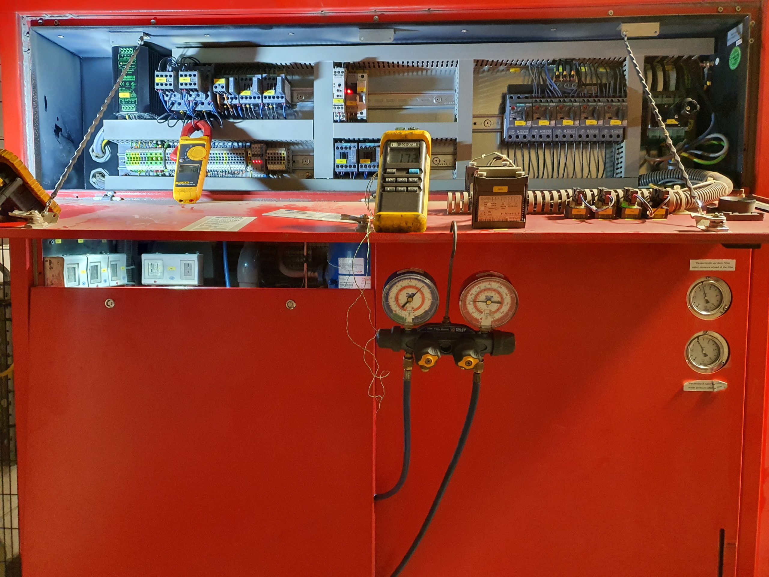 Red chiller with lantern illuminating the internal components showing test equipment for checking chiller efficiency