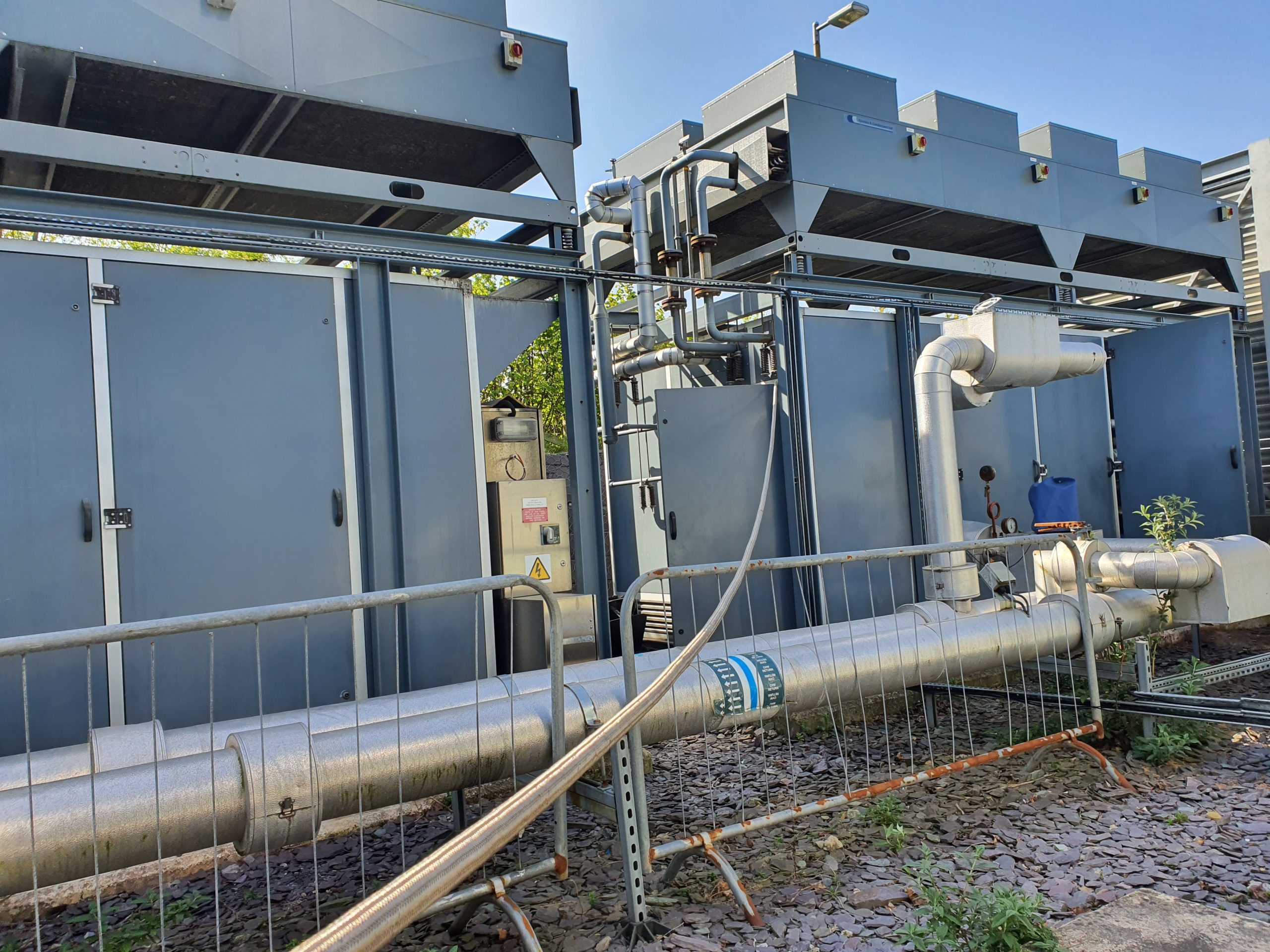 Example of chiller types: 2 grey containerised ammonia chillers with air cooled condensers on top