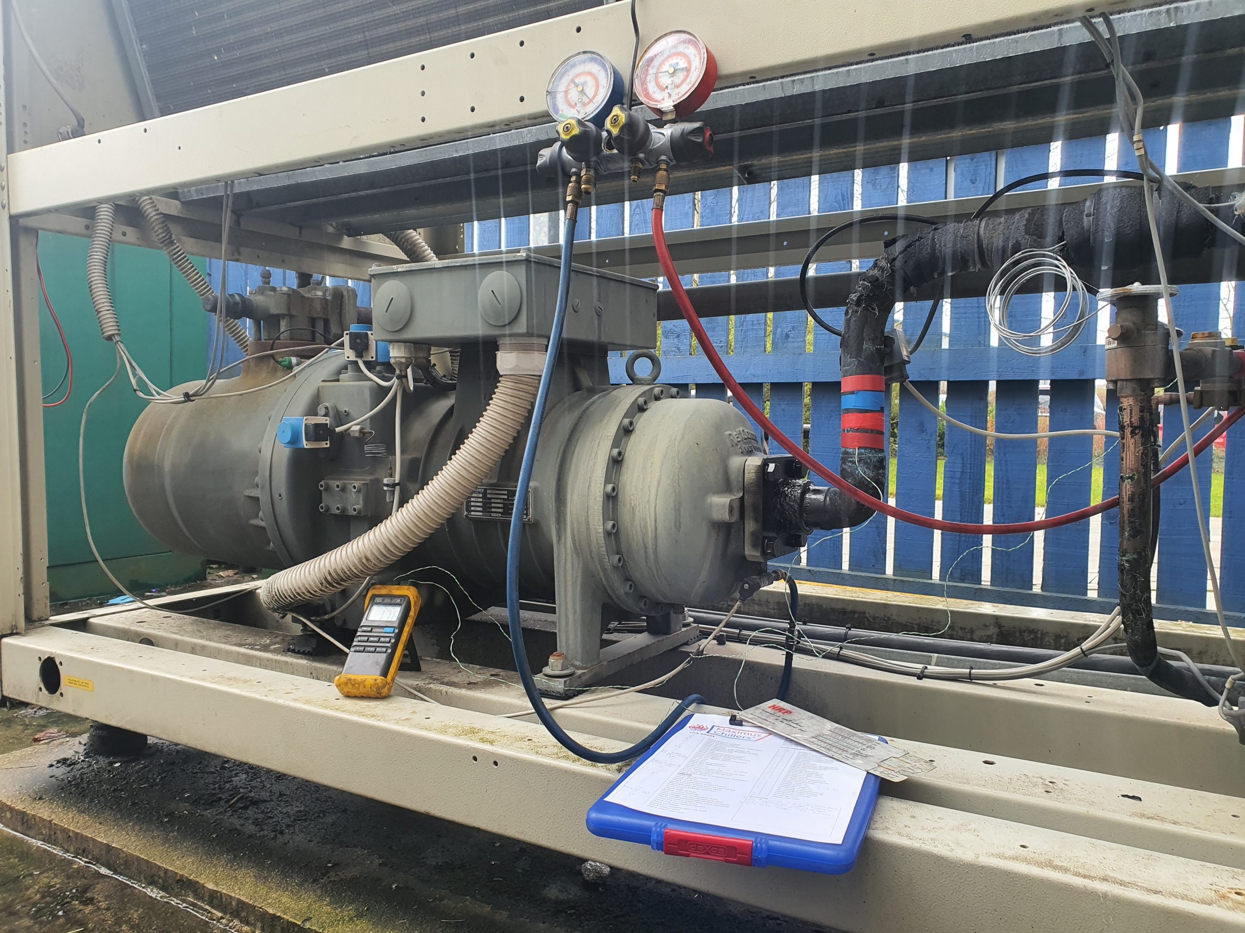 Test equipment attached to chiller during chiller maintenance contract visit