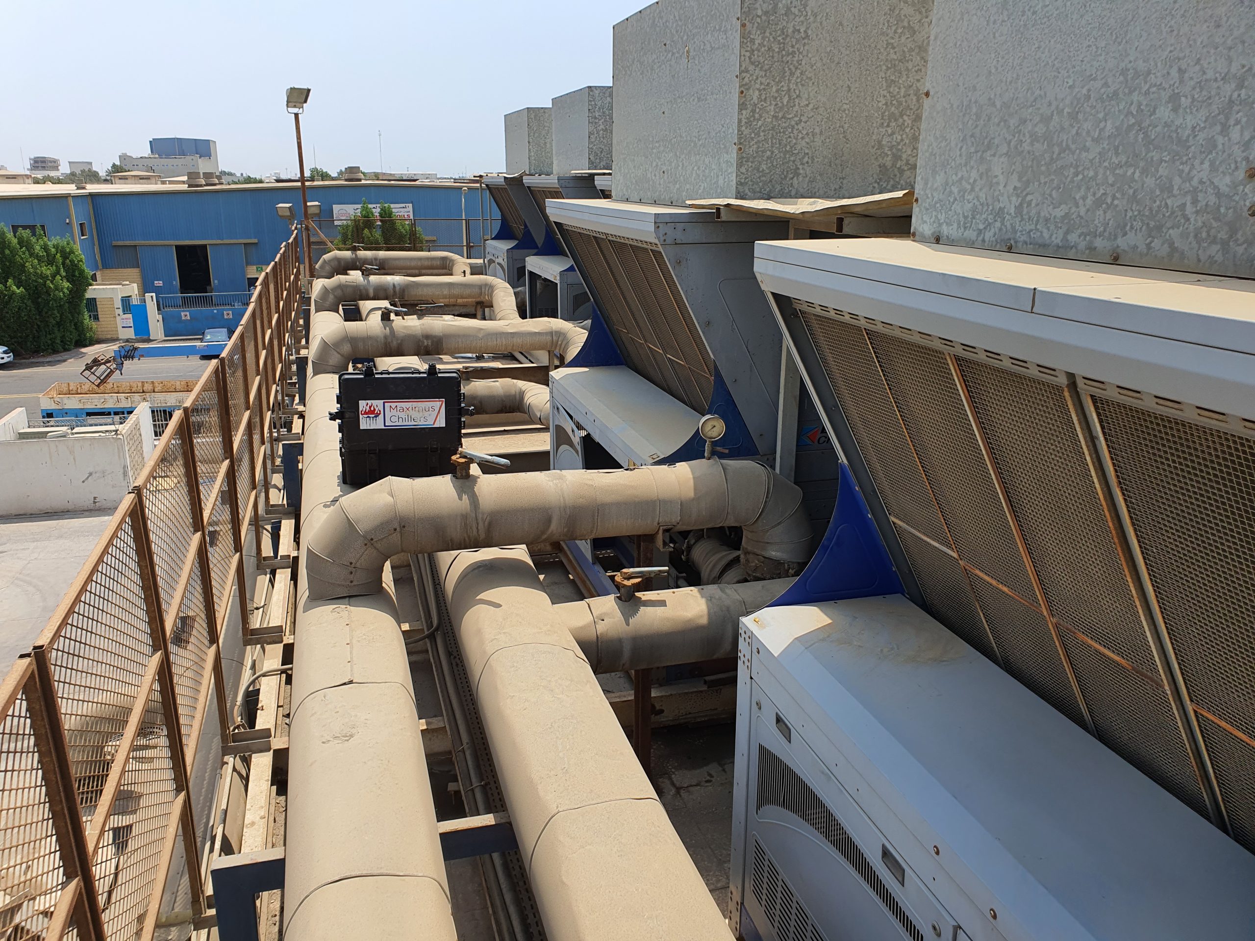 Chiller repair company for a row of grey air cooled chillers in Saudi