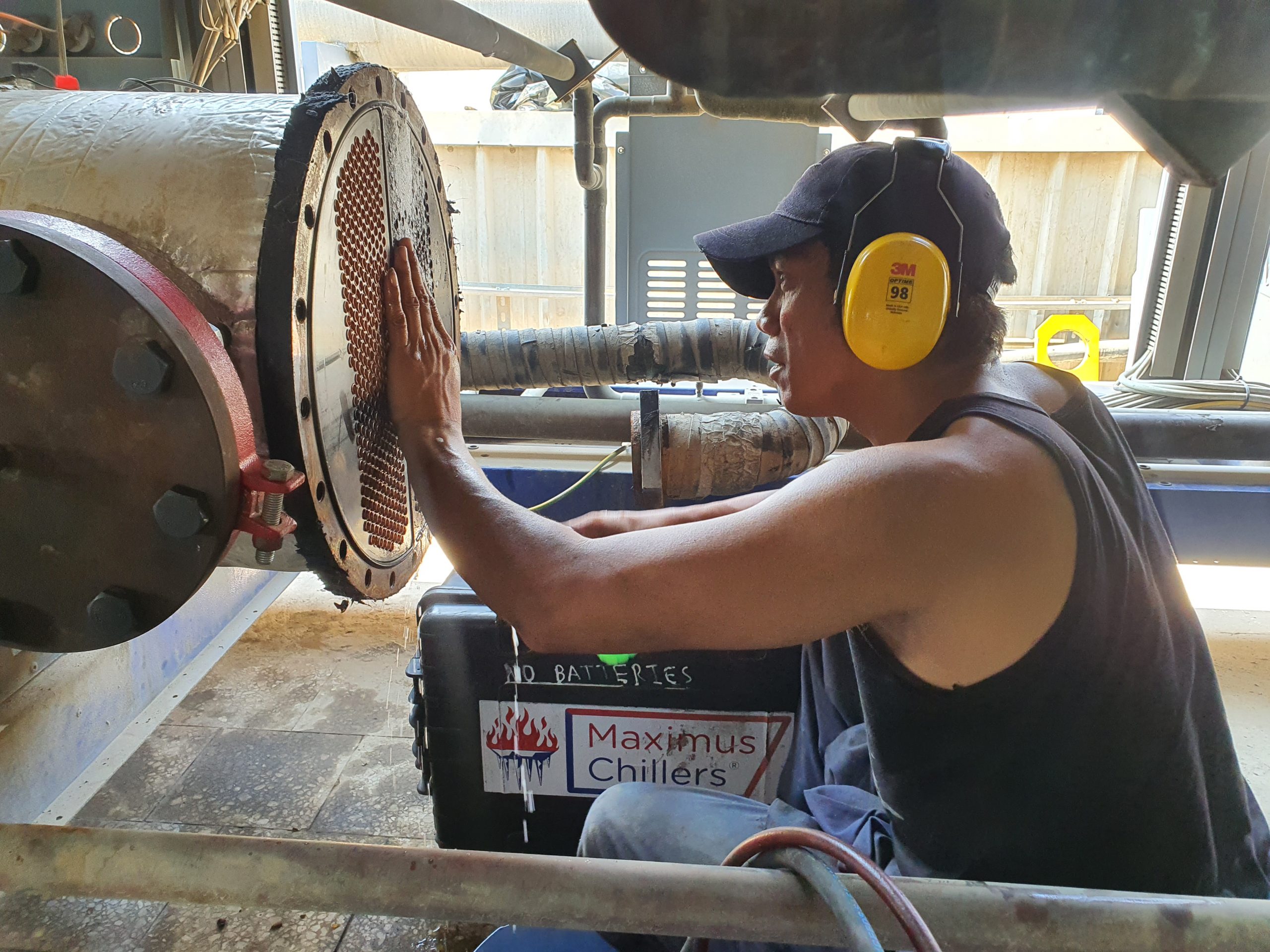 Technician in Saudi working on a chiller evaporator during the repair